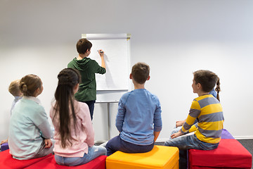 Image showing student boy with marker writing on flip board