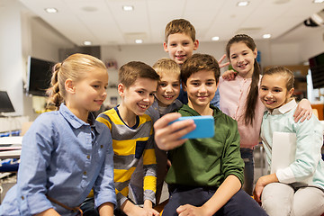 Image showing group of school kids taking selfie with smartphone