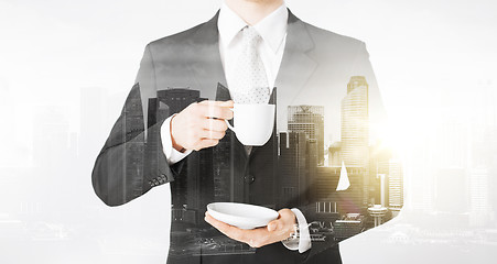 Image showing close up of businessman drinking coffee from cup