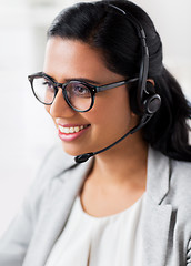 Image showing businesswoman with headset talking at office