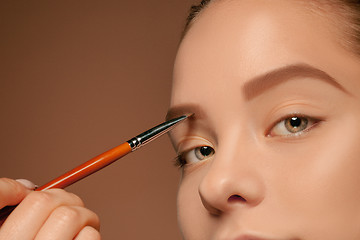 Image showing Beautiful female eyes with make-up and brush