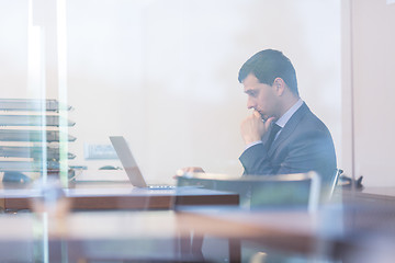 Image showing Elegant businessman analyzing data in modern office.