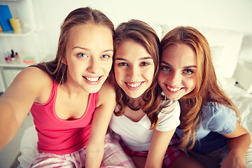 Image showing happy friends or teen girls taking selfie at home
