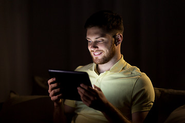 Image showing young man with tablet pc computer at night 