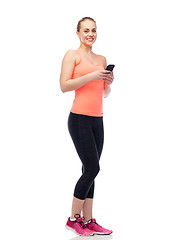 Image showing happy smiling sportive young woman with smartphone