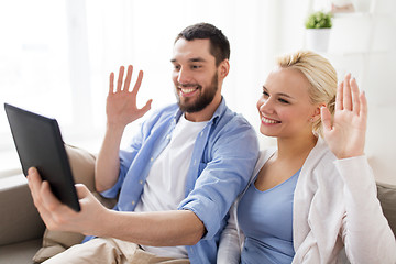 Image showing couple with tablet pc having video chat at home