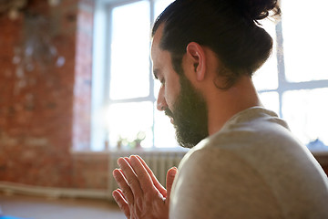 Image showing close up of man meditating at yoga studio