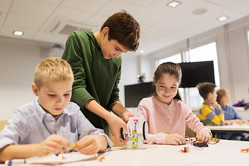 Image showing happy children building robots at robotics school