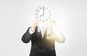 Image showing businessman with wall clock