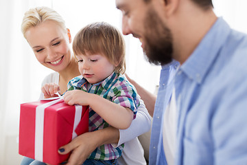 Image showing happy family with birthday gift at home