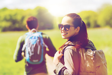 Image showing happy couple with backpacks hiking outdoors