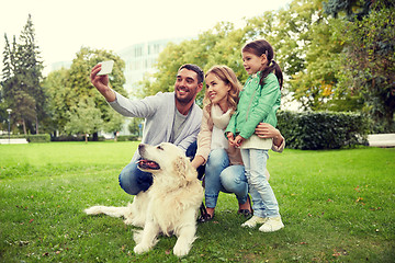 Image showing happy family with dog taking selfie by smartphone