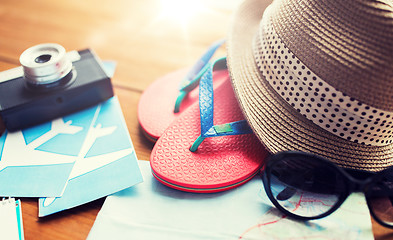 Image showing close up of travel map, flip-flops, hat and camera