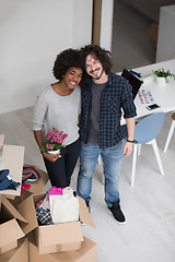 Image showing multiethnic couple moving into a new home