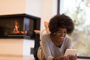 Image showing black women using tablet computer on the floor