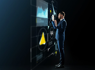 Image showing businessman working with virtual projection