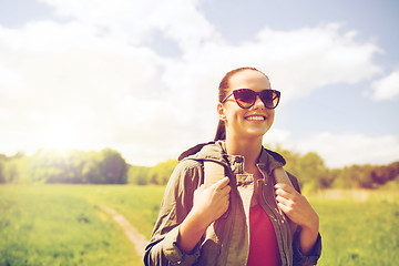 Image showing happy young woman with backpack hiking outdoors