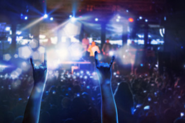 Image showing The silhouettes of concert crowd in front of bright stage lights