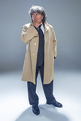 Image showing The senior man as detective or boss of mafia on gray studio background