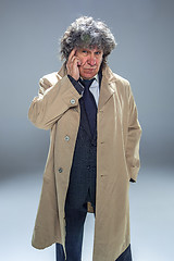 Image showing The senior man as detective or boss of mafia on gray studio background