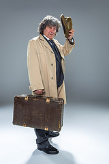 Image showing The senior man as detective or boss of mafia on gray studio background