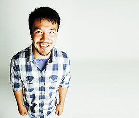 Image showing young cute asian man on white background gesturing emotional, po