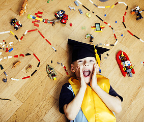 Image showing little cute preschooler boy among toys lego at home in graduate 