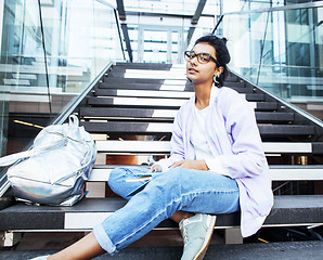 Image showing young cute indian girl at university building sitting on stairs 