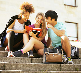 Image showing cute group of teenages at the building of university with books huggings, back to school