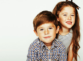 Image showing little cute boy and girl hugging playing on white background, ha