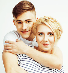 Image showing young pretty teenage couple, hipster guy with his girlfriend happy smiling and hugging isolated on white background, lifestyle people concept closeup