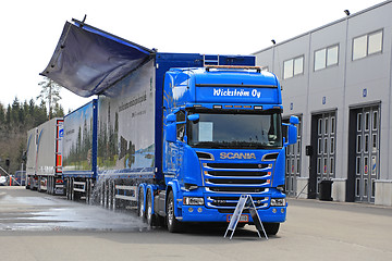 Image showing Scania Woodchip Truck Dumps Water