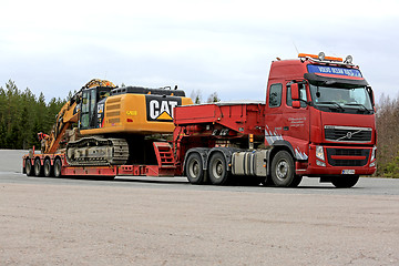 Image showing Red Volvo FH Hauls Large Excavator on Trailer