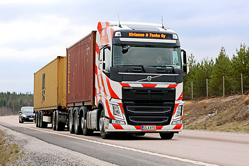 Image showing Volvo FH with Red Stripes Hauls Containers along Road