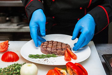 Image showing Chef set grilled meat