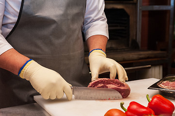 Image showing Chef cutting meat