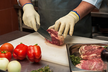 Image showing Chef cutting meat