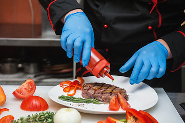 Image showing Chef set grilled meat