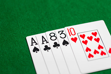 Image showing poker hand of playing cards on green casino cloth