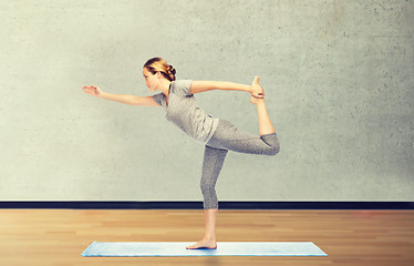 Image showing woman making yoga in lord of the dance pose on mat