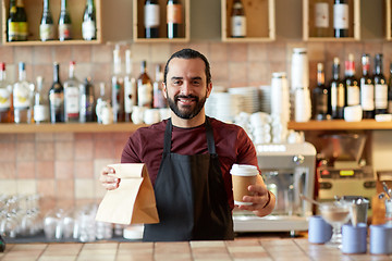 Image showing man or waiter with coffee and paper bag at bar