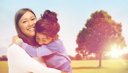 Image showing happy mother and daughter hugging outdoors