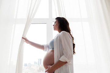 Image showing happy pregnant woman with big tummy at home