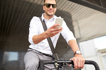 Image showing man with smartphone and fixed gear bike on street