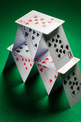 Image showing close up of house of playing cards on green cloth