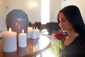 Image showing woman with rose and funerary urn at church