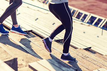 Image showing close up of couple running downstairs on stadium