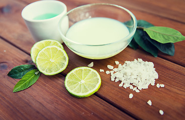 Image showing close up of body lotion, cream and salt on wood