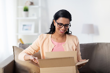 Image showing happy young indian woman with parcel box at home