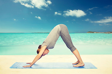 Image showing woman making yoga dog pose on mat